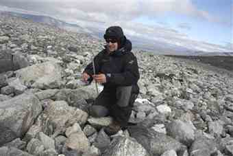Norwegian archaeologist Elling Utvik Wammer picks up a stick believed to be about 1,500 years old and used by ancestors of the Vikings to hunt reindeer in the Jotunheimen mountains of Norway September 9, 2010.