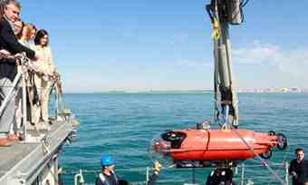 Spanish ministers watch as a Pluto submarine is lowered into the sea off Cadiz. The navy is trying to protect Spain's historical heritage from private salvagers. Photograph: AP