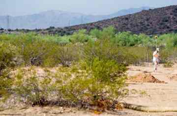 Principal investigator Mark Hackbarth, of Scottsdale, marks the land.