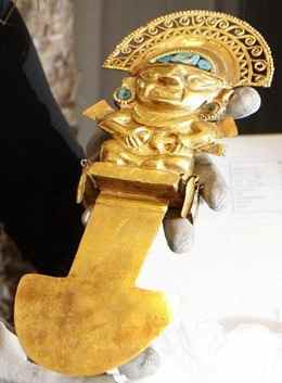 A golden sacrificial knife is shown by an employee of the Novomatic Forum in Vienna