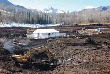 Crews dig for fossils in various spots at Ziegler Reservoir, near Snowmass Village, in early November. Mount Daly looms in the background. The location of the initial find, a mammoth, is enclosed in the tent. [Janet Urquhart/Aspen Times Weekly]
