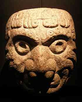 Chavin stone art in the shape of a head, housed at the Museo De La Nacion in Lima, Peru. The 3,000 year-old Chavin culture produced tunnels and mazes with eerie sound effects.
