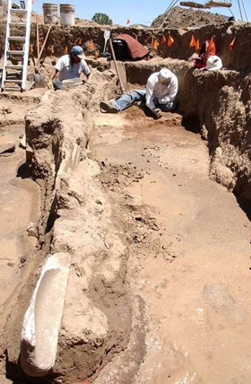 SWCA archaeologists carefully excavate the front of a large Pueblo I pit house in 2005. Evidence from the dig suggests a violent event including traits consistent with cannibalism occurred in this pit.