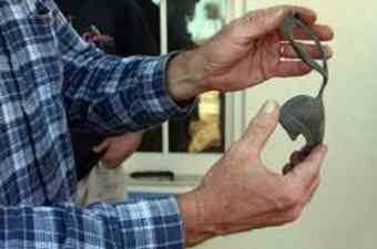 St. Augustine city archeologist Carl Halbirt holds a hilt used to hold a British soldier's sword that was found on the grounds of the St. Augustine Pirate and Treasure Museum.
