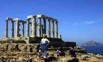 Tourists at the temple of Poseidon at Sounion – one of Greece's many ruins in desperate need of restoration. Photograph: Aris Messinis/AFP/Getty Images