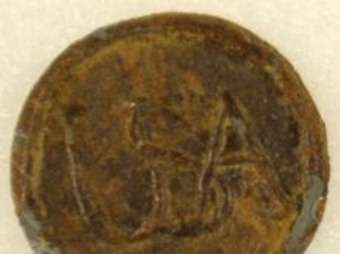A continental army button with the leters USA on it from the Revolutionary War found at Alamance Battleground State Historic Site. photo sam roberts  