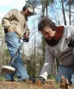 Jim and Vickie Spivey search for artifacts at the Alamance Battlegound State Historic Site Friday. Photo Shawn M. Franks  