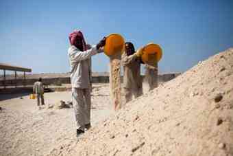Aides work on the restoration of the monastery.