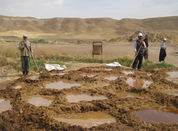 Workers mixing up an adobe slurry as part of on-going restoration work. Photo: Jill Worrall 