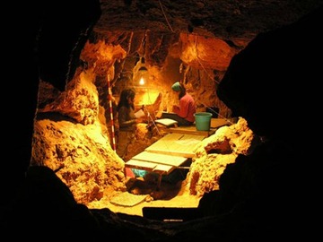 Archaeologists excavate the cave in El Sidron in Asturias, northern Spain