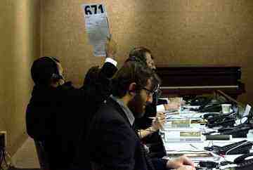 A phone bidder holds up a sign to place a bid for an absent client during a Native American art auction at Bonhams and Butterfields in San Francisco, Monday, Dec. 6, 2010. 