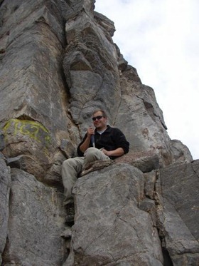Researcher Benjamin Gill near the top of a stratigraphic section at Lawsons Cove, Utah. (Credit: Steve Bates.)