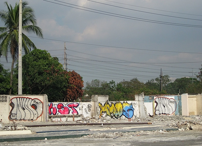 demolished building with walls painted with graffiti