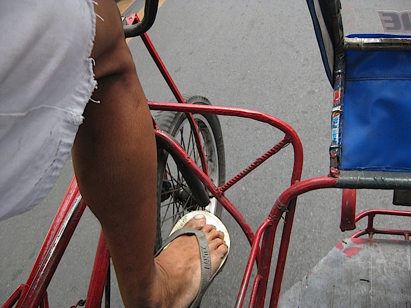 a view of the road from inside a pedicab