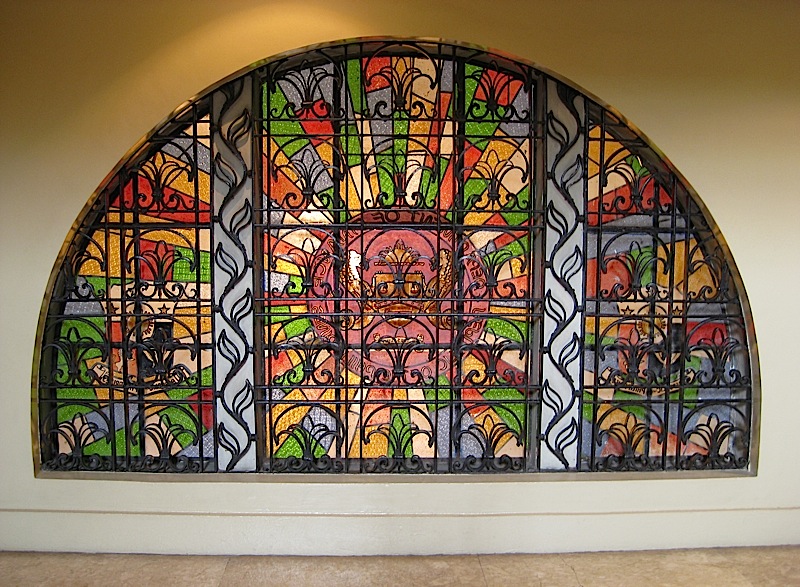 arched stained glass window with black iron grills at the Museum of the Filipino People