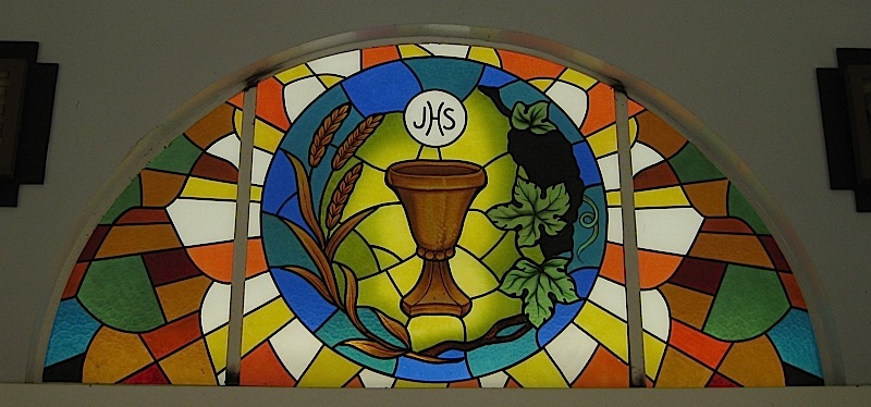 stained glass window with wheat, grape vines and a chalice