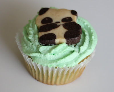 photo of one cupcake with a panda cookie on top