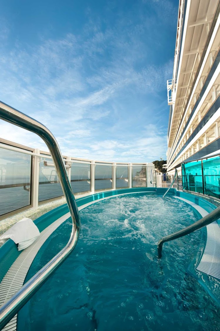 Enjoy the view while unwinding in a whirlpool on Carnival Dream's Lanai promenade.
