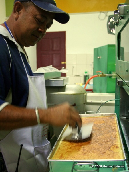 [pressing down last layer of sarawak layer cake - copyright house of annie[3].jpg]
