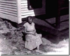 Grandma Milligan sitting in front of house cropped