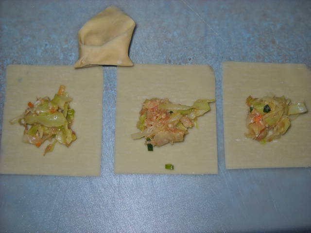 won tons with scoop of filling in the them ready to be folded 