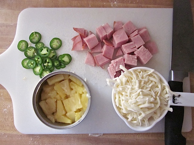 pizza toppings on cutting board 