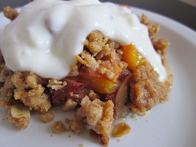 Platte of Peach Almond Crisp with vanilla yogurt on top 
