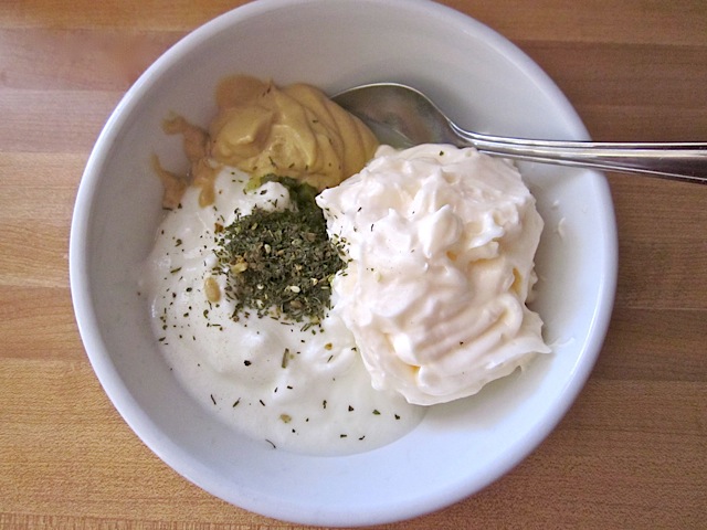 sauce ingredients in white bowl with spoon 