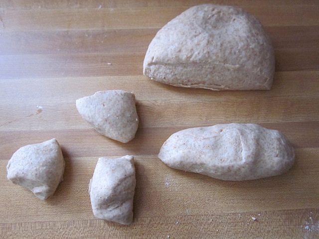 Tortilla dough being divided into pieces 
