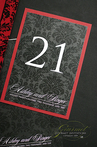 Black damask table numbers with a red backer