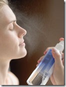 woman spraying hydrating mist