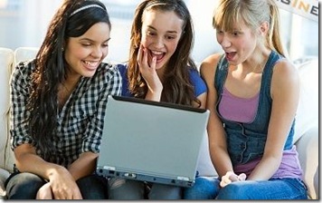 women laughing - looking at laptop