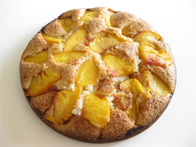 overhead photo of a cake with fresh peaches on top
