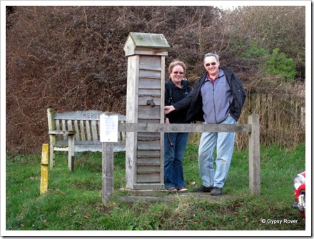 Derek and Elizabeth at the village water pump in Kersey, Suffolk. The seat is a memorial to a couple named Kersey.