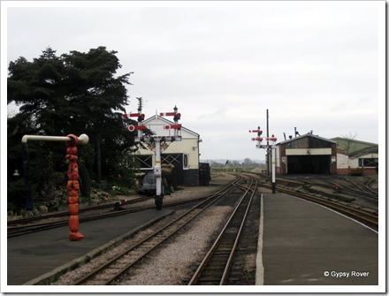 New Romney railway station and engine shed. The train under camouflage on the left is a replica of a WWII defence train.