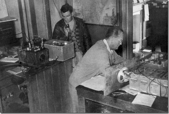 Aeradio men Charles Pedell (left) and J Pickles operate emergency equipment. Kempsey floods 1949