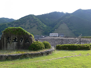 View of the stone monument and embankment of the Blue Earth Dam