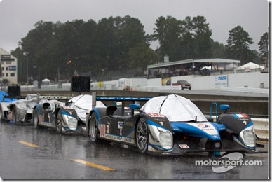 Cars lined up on pitlane as the race is stopped because of the heavy rain