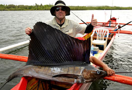 Canadian angler Richard Sharpe proudly shows a sailfish he caught 
off the fishing village of Pilar on Siargao Island during the ‘3rd 
Siargao Gamefishing Tournament 2010’ where anglers from at least 14 
countries participated. (AFP)