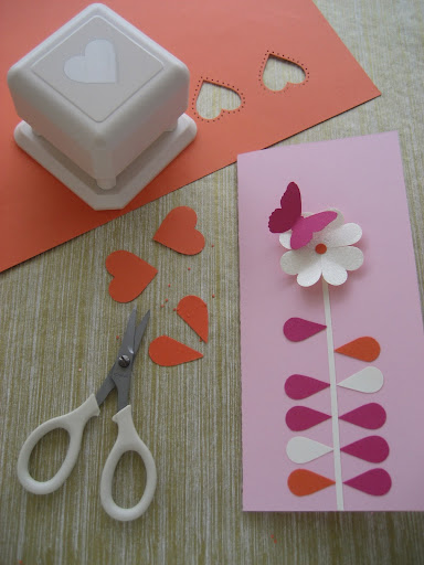 Cutting the hearts in half to create leaves. The punch here is the Martha Stewart Crafts Punch All Over the Page studded heart punch.