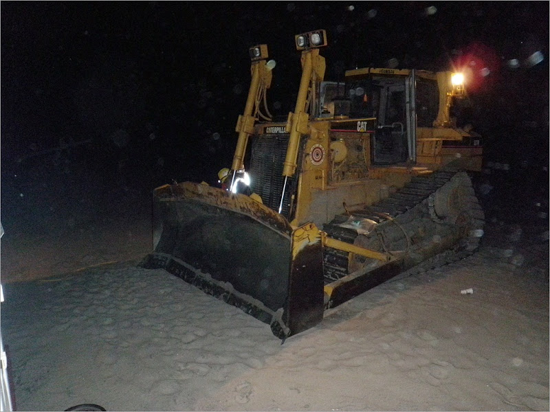 A dozer used to move the sand around the beach. the specs that you see here is the flying sand that was a constent irritent during my first week here.