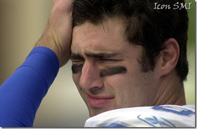 The Lions' Joey Harrington wipes his brow during a loss to the Chicago Bears.