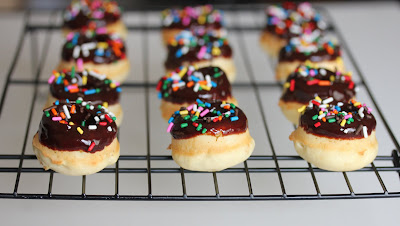 photo of mini donuts with sprinkles on a baking rack