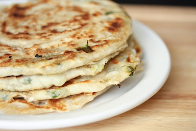 close-up photo of Green Onion Pancakes stacked on a plate