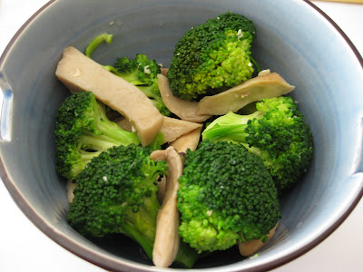  a bowl of mushroom broccoli stirfry.