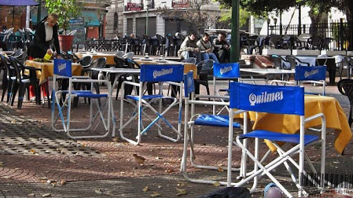 Chairs and Tables of a Restaurant at the Plaza Dorrego advertising Quilmes Beer in Buenos Aires, Argentina