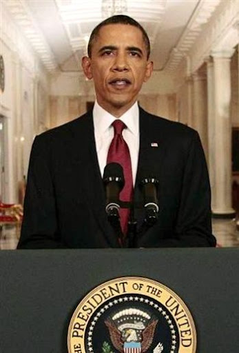 Obama stands at podium