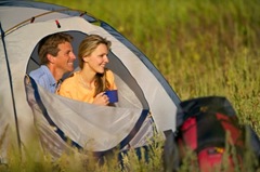 couple_in_tent_shows_backpack