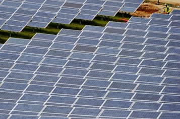 A technician inspects newly installed solar panels. AFP / File, Boris Horvat
