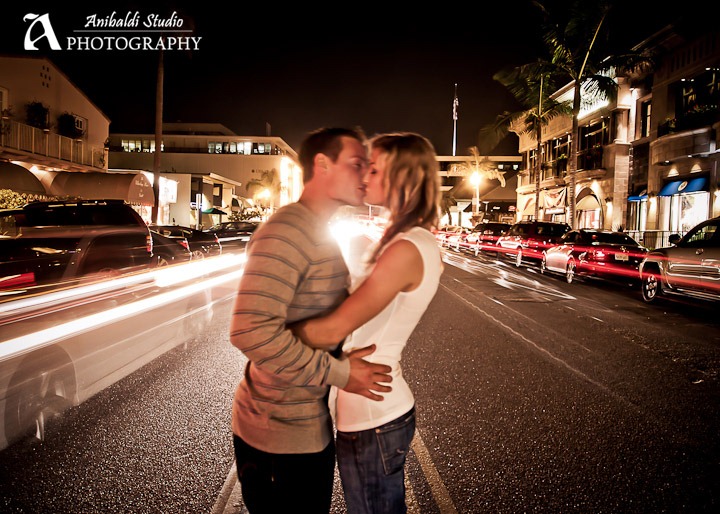 kissing in city street at night